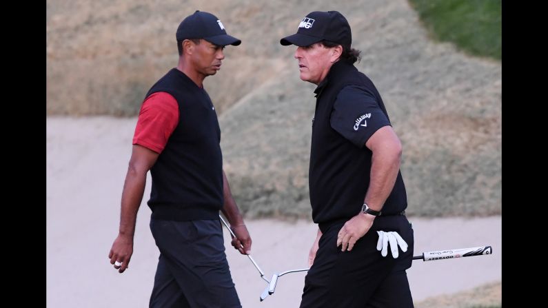 Tiger Woods and Phil Mickelson walk on the 18th hole during The Match: Tiger vs Phil on Friday, November 23, in Las Vegas. Mickelson defeated Woods in 22 holes.