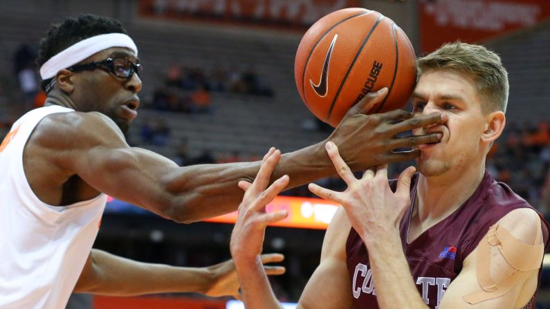 Syracuse Orange center Paschal Chukwu hits Colgate Raiders forward Rapolas Ivanauskas in the face while reaching for a loose ball during the first half of a game on Wednesday, November 21 in Syracuse, New York.