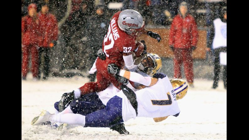 James Williams of the Washington State Cougars carries the ball against the Washington Huskies on Friday, November 23 in Pullman, Washington. Washington defeated Washington State 28-15.