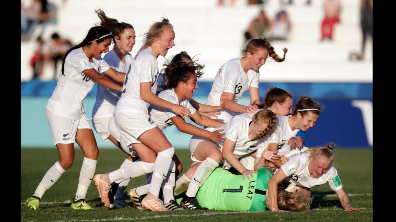 New Zealand players embrace goalkeeper Anna Leat, after she scores the final penalty during a penalty shootout in a FIFA U-17 Women's World Cup soccer match against Japan in Colonia del Sacramento, Uruguay, Saturday, November 24.