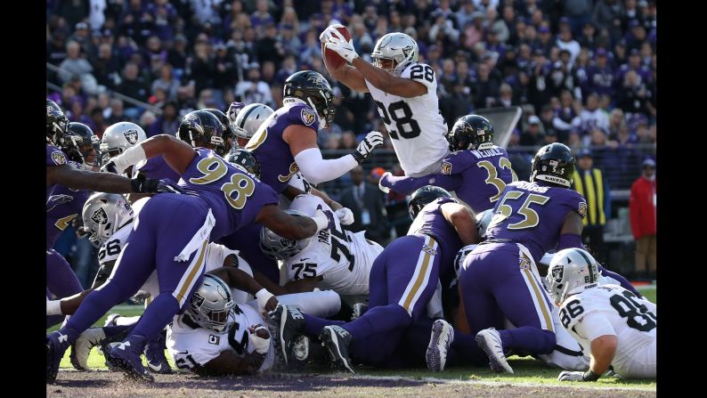 Doug Martin of the Oakland Raiders leaps for a touchdown in the first quarter against the Baltimore Ravens on Sunday, November 25 in Baltimore.