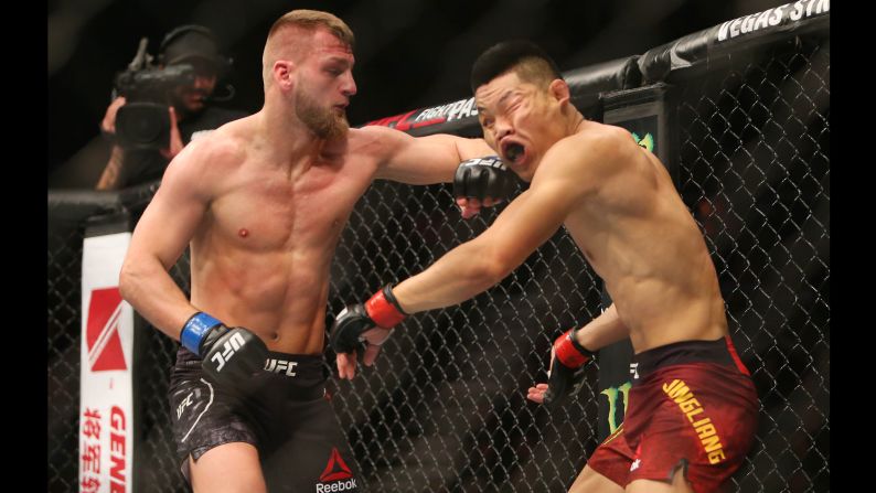 Li Jingliang, right, competes against David Zawada during UFC Fight Night in Beijing, China on Saturday, November 24.