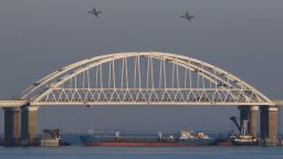 REFILE - CORRECTING GRAMMAR & BYLINE Russian jet fighters fly over a bridge connecting the Russian mainland with the Crimean Peninsula with a cargo ship beneath it after three Ukrainian navy vessels were stopped by Russia from entering the Sea of Azov via the Kerch Strait in the Black Sea, Crimea November 25, 2018. REUTERS/Pavel Rebrov