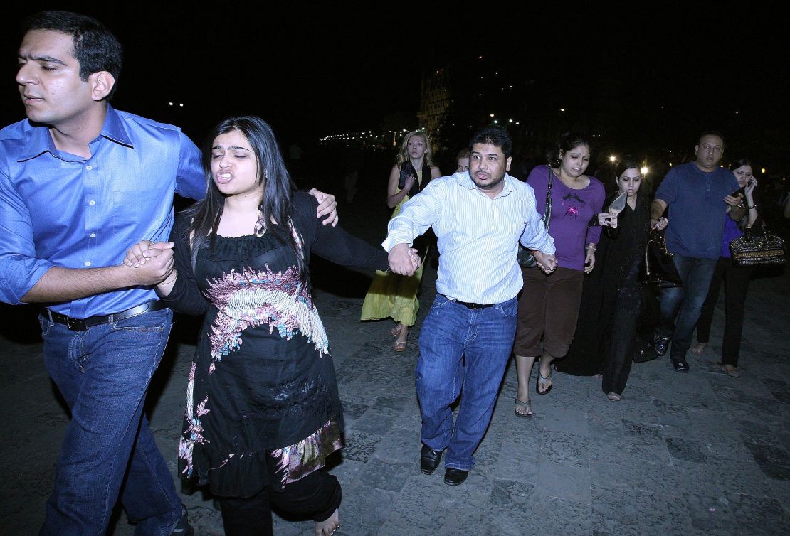 Indian and foreign guests rush out of the Taj Mahal hotel, as news of the attack breaks out. 