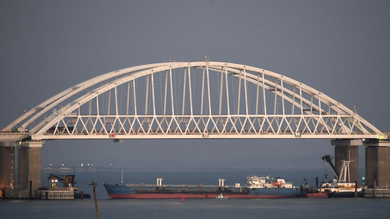 A ship under the the Kerch bridge blocks the passage to the Kerch Strait near Kerch, Crimea, Sunday, Nov. 25, 2018. Russia and Ukraine traded accusations over an incident at sea Sunday near the disputed Crimean Peninsula, increasing tensions between both countries and prompting Moscow to block passage through the Kerch Strait. (AP Photo)