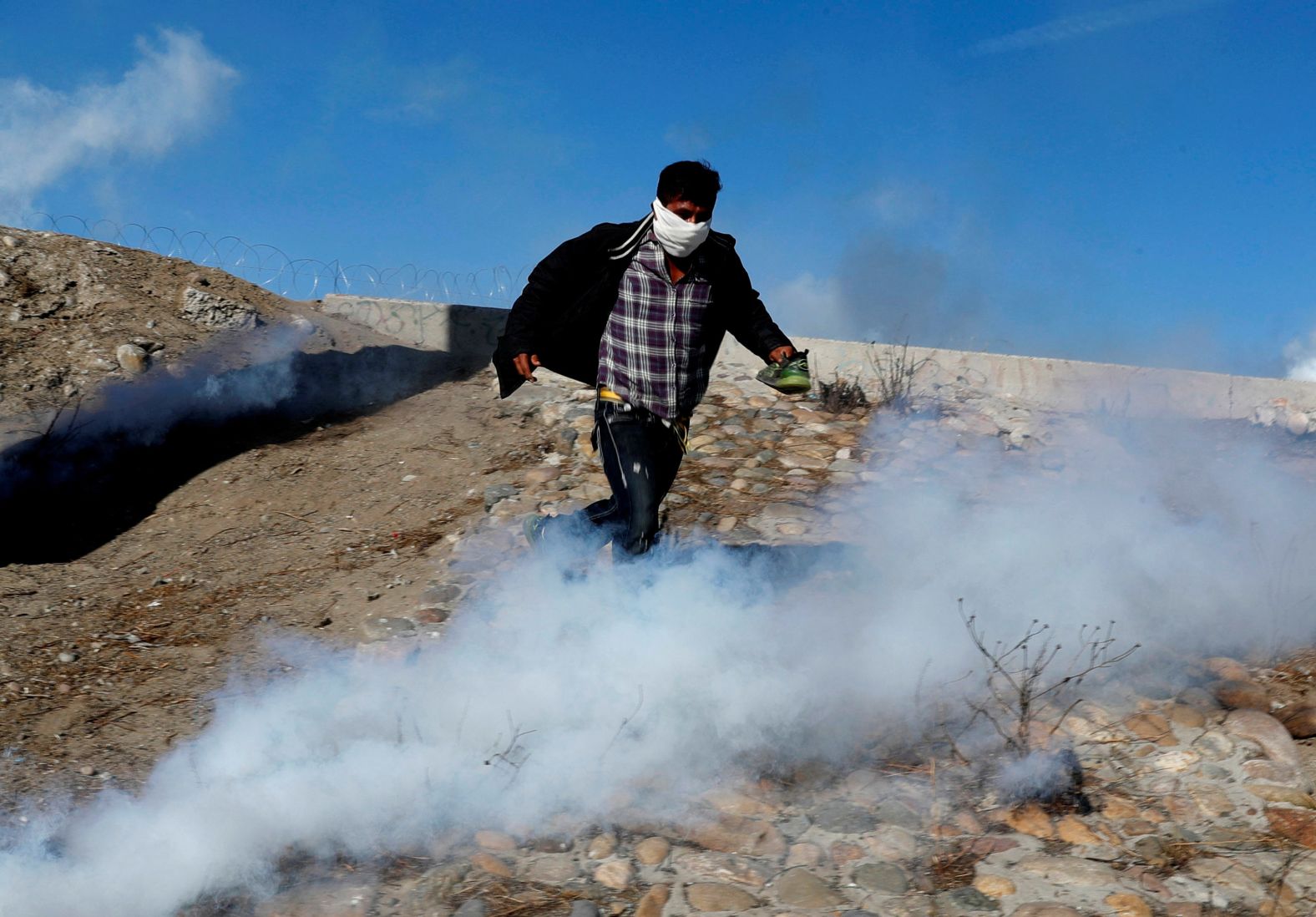 A migrant runs from tear gas on November 25. Research shows that asylum seekers from Honduras, Guatemala and El Salvador <a href="index.php?page=&url=https%3A%2F%2Fwww.cnn.com%2F2018%2F05%2F03%2Fworld%2Fus-asylum-denial-rates-by-nationality%2Findex.html" target="_blank">have relatively low odds of gaining asylum</a> in the US. 