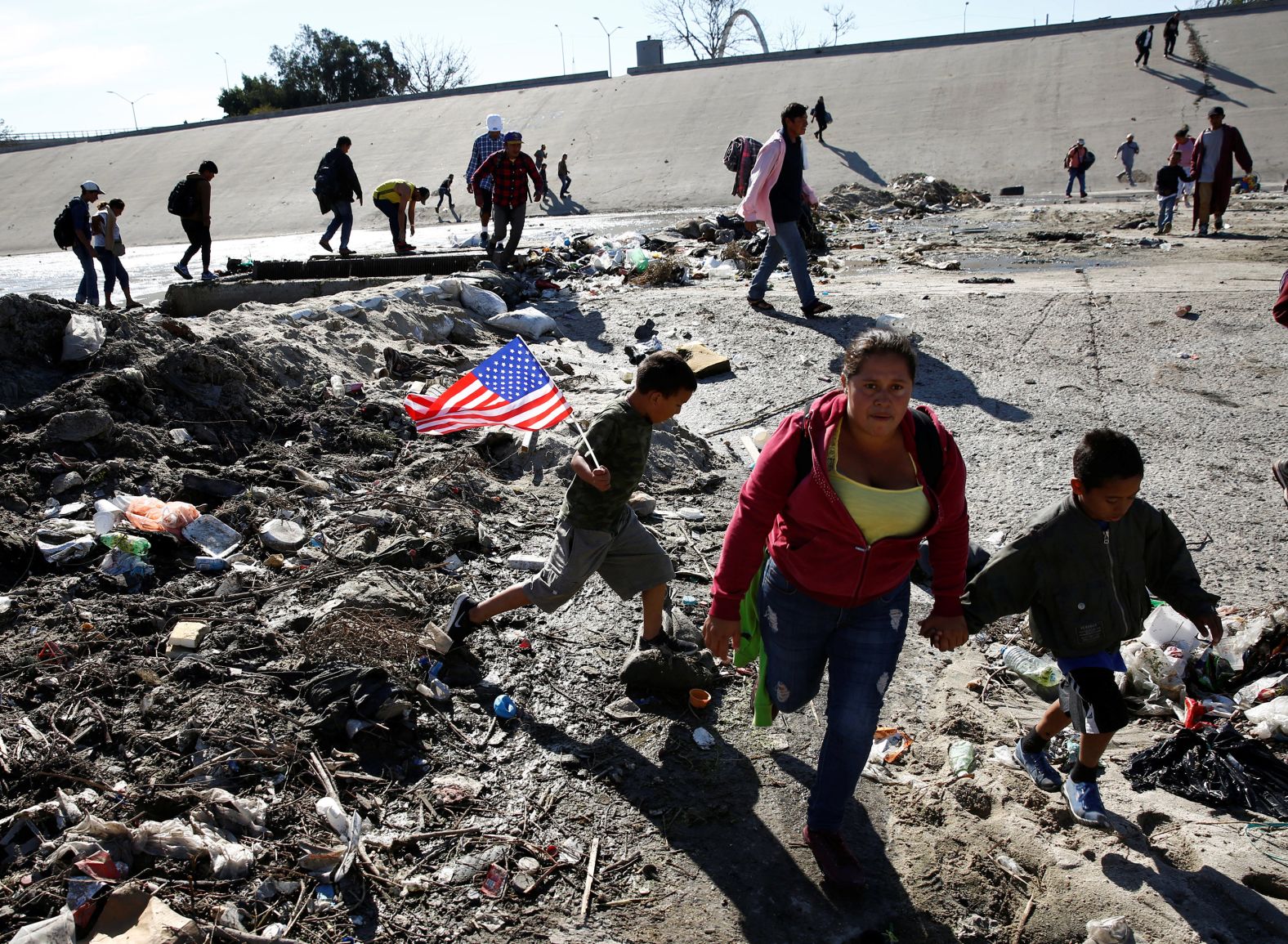 Migrants run to cross the Tijuana River on November 25. While many migrants say they plan to seek asylum in the US, the <a href="index.php?page=&url=https%3A%2F%2Fwww.cnn.com%2F2018%2F07%2F11%2Fpolitics%2Fborder-immigrants-asylum-restrictions%2Findex.html" target="_blank">rules for gaining asylum recently got much tougher</a>. 