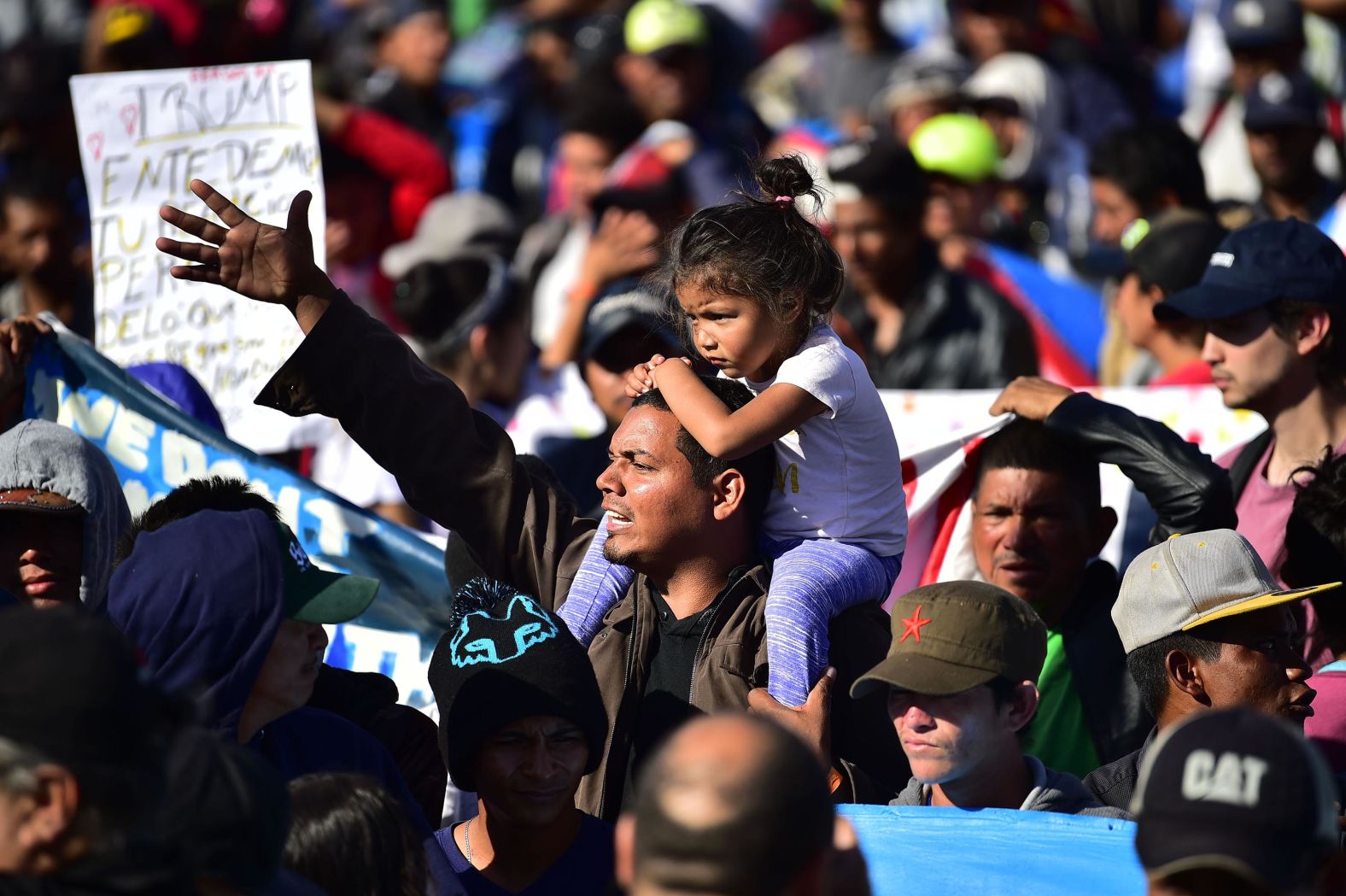 Migrants are stopped by Mexican police officers before arriving at the port of entry.