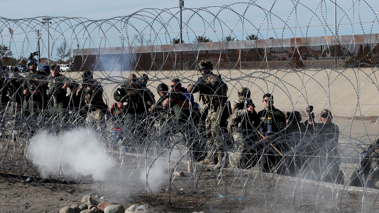 U.S. soldiers and U.S. border patrols fire tear gas towards migrants, part of a caravan of thousands traveling from Central America en route to the United States, from the U.S.side of the border fence between Mexico and the United States in Tijuana, Mexico, November 25, 2018. REUTERS/Kim Kyung-Hoon