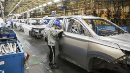 An employee inspects a vehicle in the weld shop at the SAIC-GM-Wuling Automobile Co. Baojun Base plant, a joint venture between SAIC Motor Corp., General Motors Co. and Liuzhou Wuling Automobile Industry Co., in Liuzhou, Guangxi province, China, on Wednesday, May 23, 2018. GM and its partners sold 4 million vehicles in China in 2017, about 1 million more than the automaker sold in the U.S. 