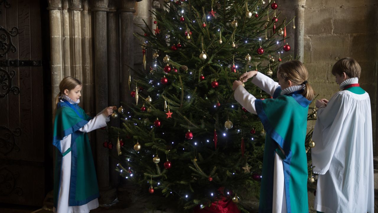 <strong>Advent in the United Kingdom:</strong> Choristers from the Salisbury Cathedral Choir decorate a Christmas tree ahead of their final practice. Christmas has been celebrated in the cathedral for over 750 years since it was dedicated in 1258.
