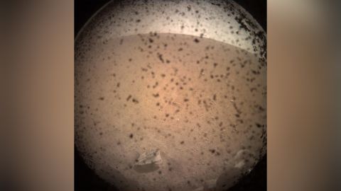 InSight's first image shortly after landing on the Martian surface on November 26, 2018.This was captured by the lander-mounted, Instrument Context Camera, with the dust shield still attached, to show the area in front of the lander.