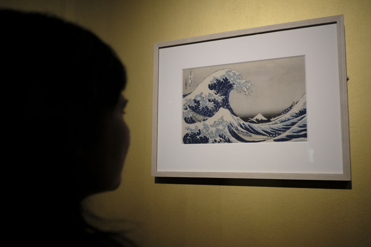 A visitor looks at Katsushika Hokusai's famous print, "The Great Wave off Kanagawa," at the Ara Pacis Museum in Rome.