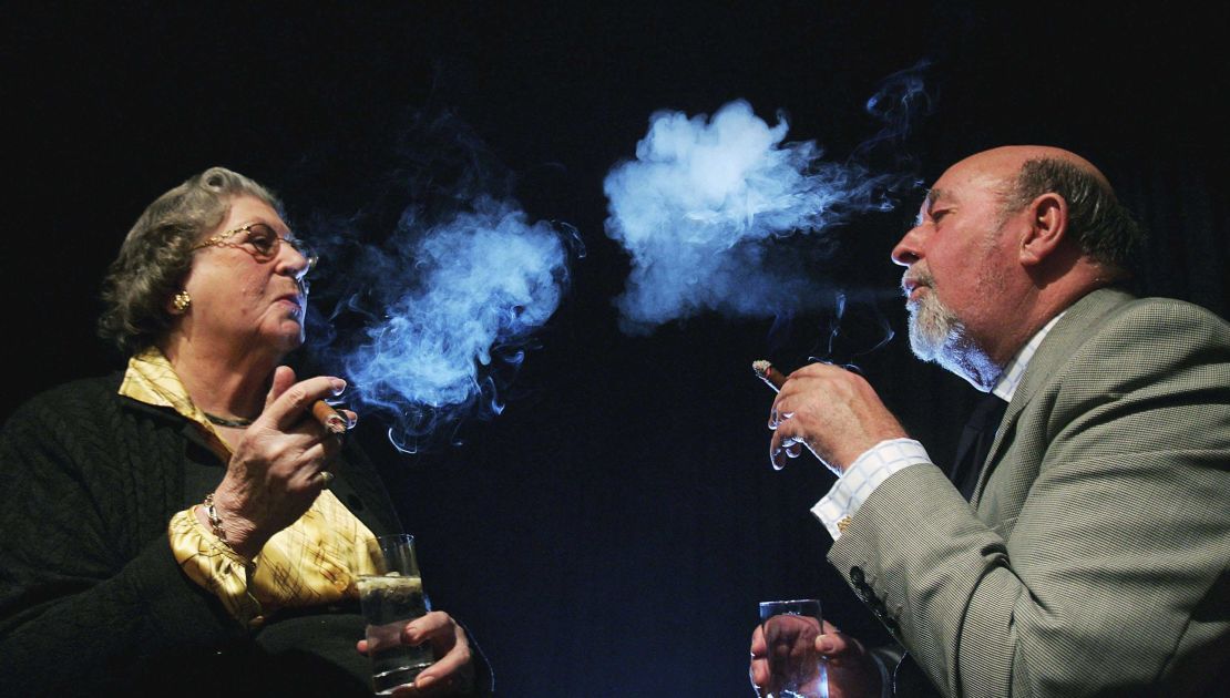 Baroness Trumpington (left) smoking a cigar with Lord Pendry in 2006