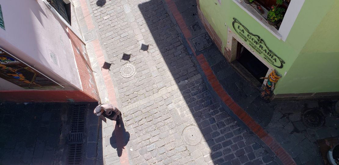 A man walks along the narrow La Ronda street in Quito.