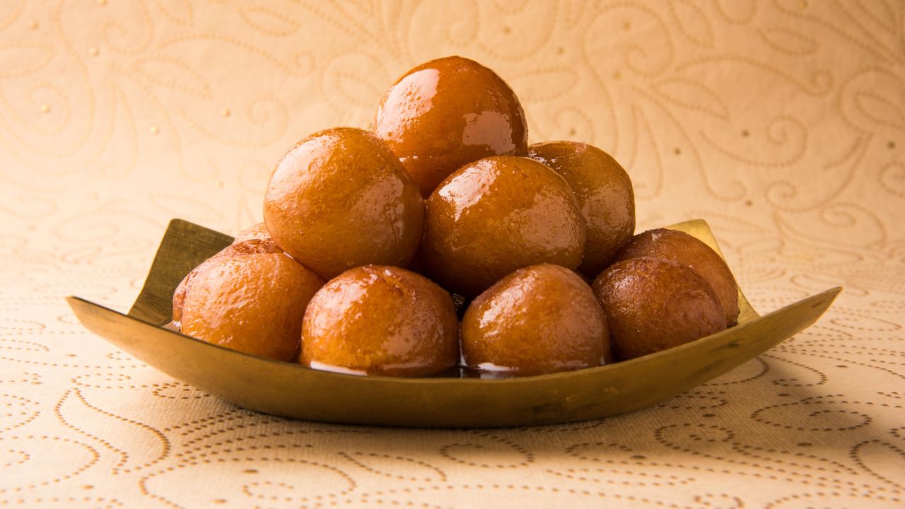 <strong>Gulab Jamun, India:</strong> Traditional recipes start with a scoop of khoya, a reduction of cow or buffalo milk that simmers for hours over a low flame, followed by frying gulab jamun in ghee and soaking in an aromatic syrup infused with cardamom seeds and roses. 