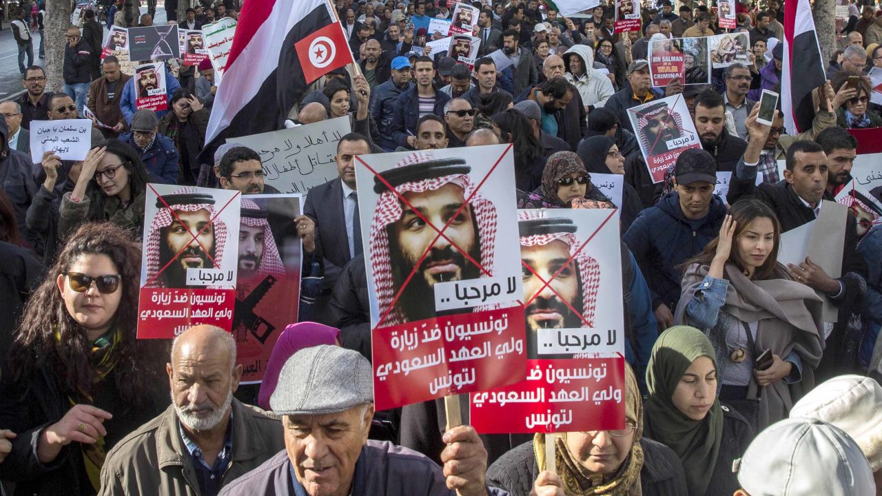 Tunisians demonstrate with placards reading 'You are not welcomed' and showing Saudi Crown Prince Mohammed bin Salman, Tuesday Nov.27, 2018 in Tunis. 