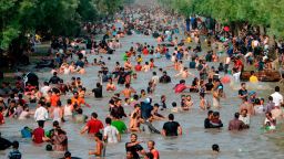 People cool themselves off in a water channel during a heat wave on June 4, 2017 in Lahore. 