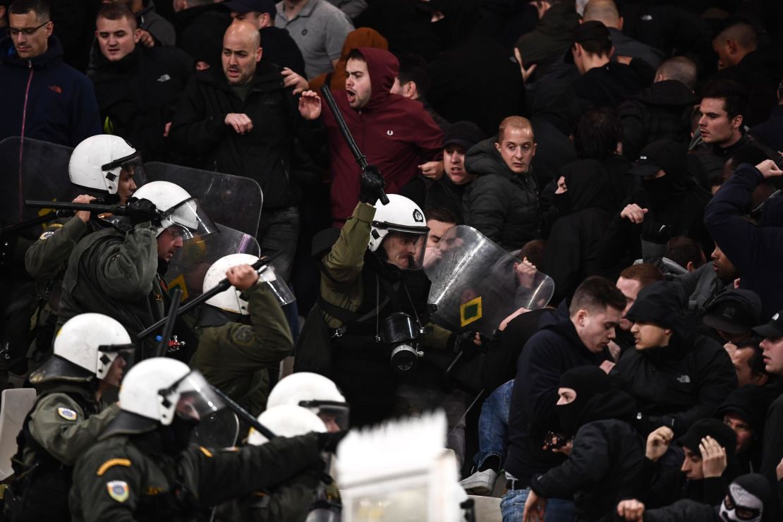 Police clash with Ajax fans at AEK's stadium in Athens. 