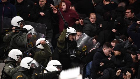 Police clash with Ajax fans at AEK's stadium in Athens. 