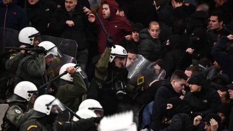 Police clash with Ajax fans at AEK's stadium in Athens.