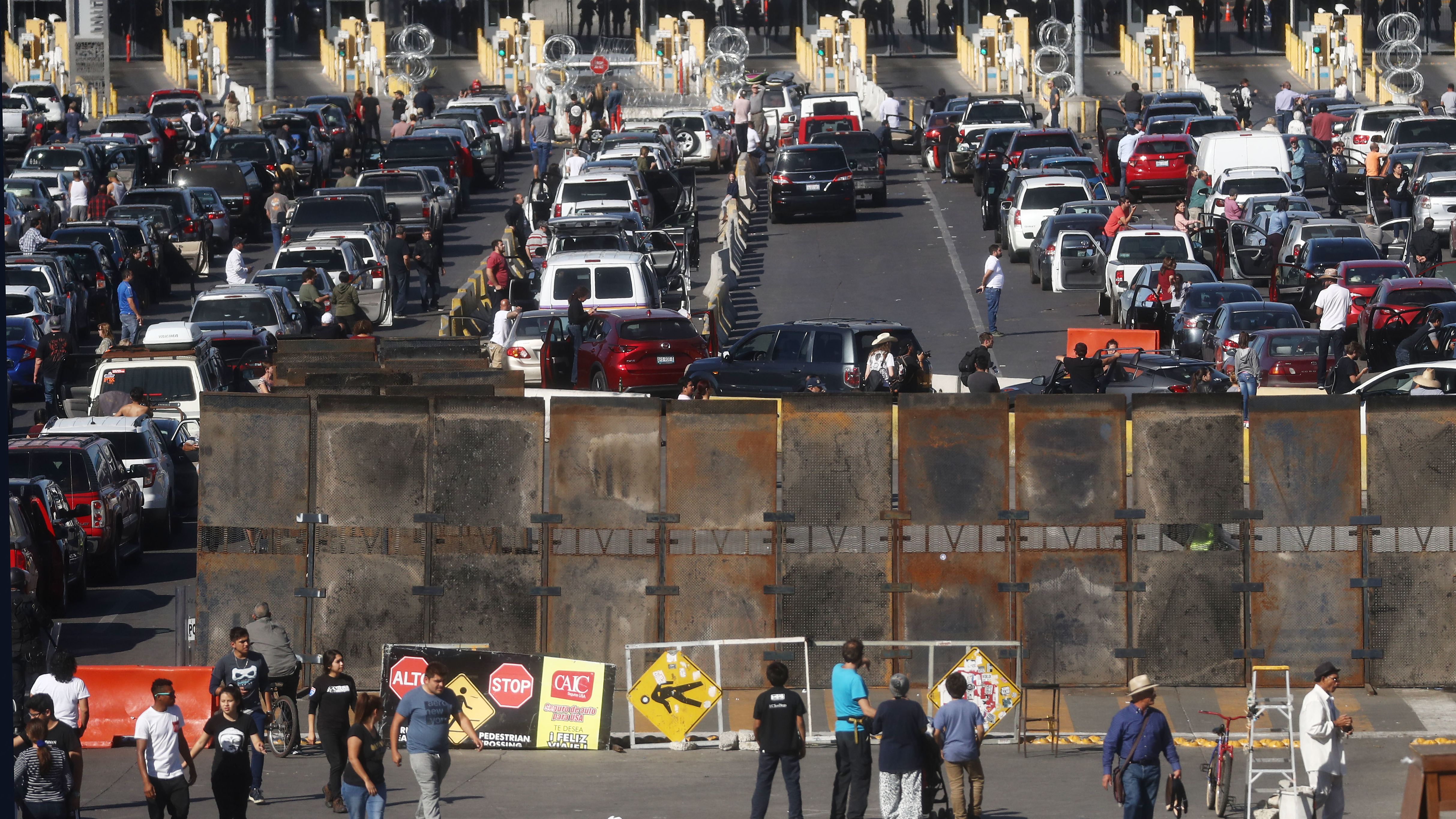 People attempting to cross in the U.S. look on as the San Ysidro port of entry stands closed at the U.S.-Mexico border on November 25, 2018 in Tijuana, Mexico.  (Photo by Mario Tama/Getty Images)