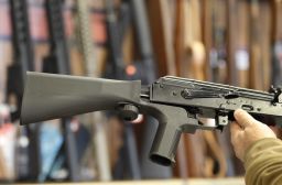 A bump stock devic, (left) fit on a semiautomatic rifle to increase the firing speed.