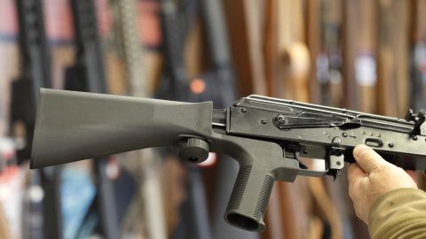 A bump stock devic, (left) fit on a semiautomatic rifle to increase the firing speed.