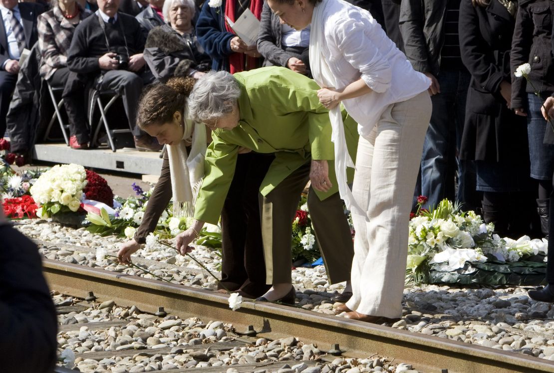 A Dutch Holocaust survivor lays flowers with her granddaughters at Westerbork in 2010 to mark the 65th anniversary of the liberation of the Dutch transit camp.