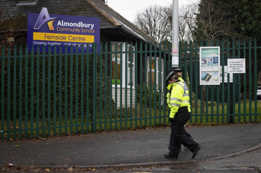 Police community support officers walk past Almondbury Community School in Huddersfield on Wednesday.