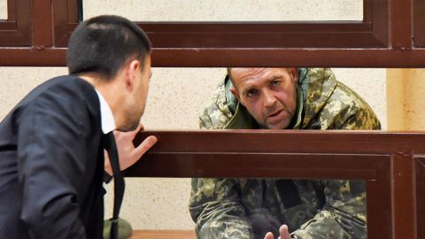 One of the captured Ukrainian sailors speaks with his lawyer in a court room Tuesday in Simferopol, Crimea.