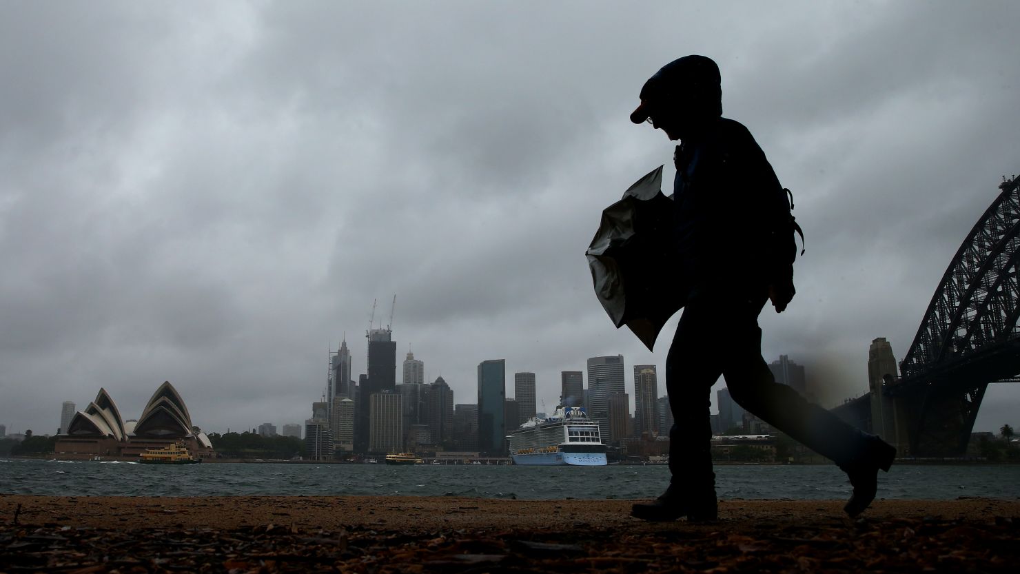 A man walks in high winds on November 28 in Sydney, Australia.