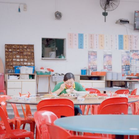 One photo shows a woman eating alone at a hawker center.