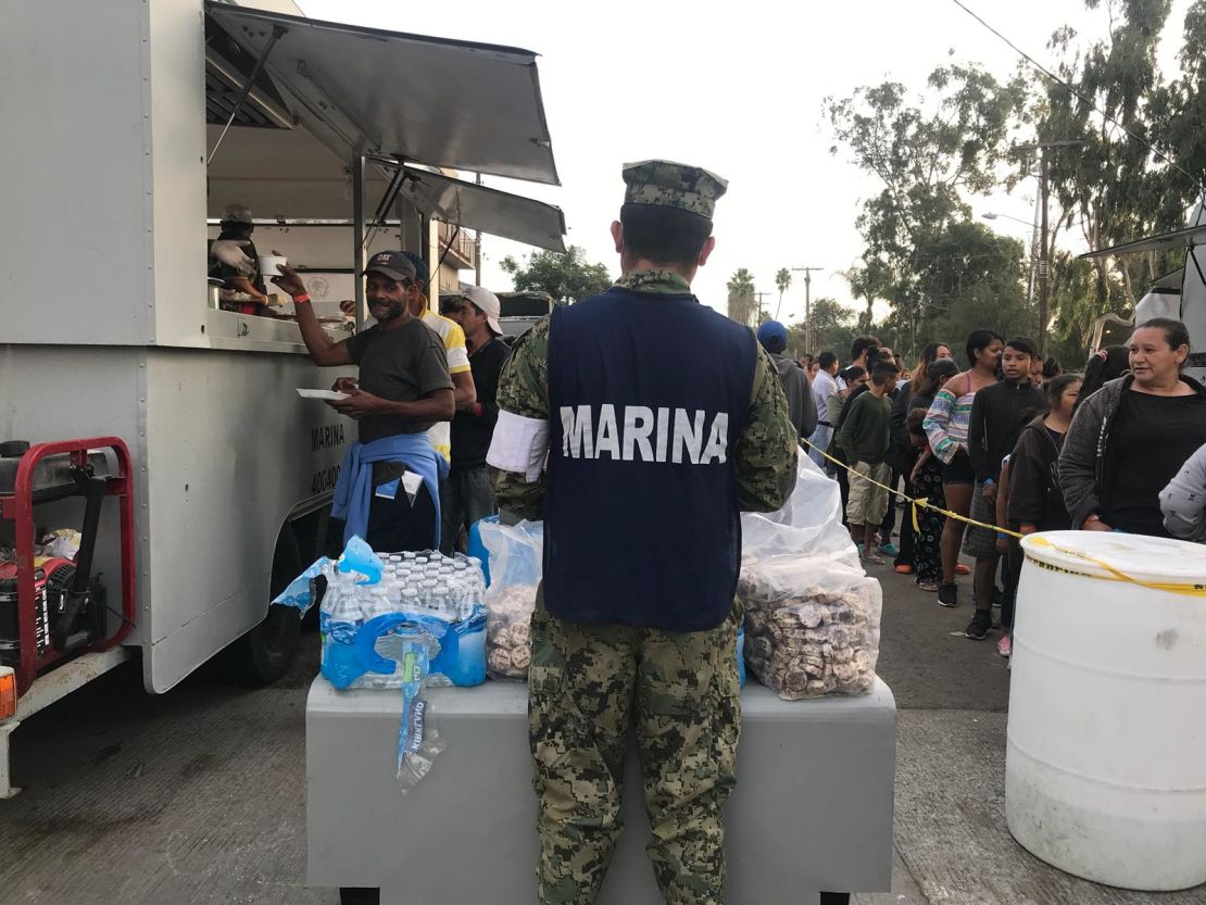 Members of the Mexican navy have set up mobile kitchens to feed migrants.