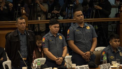 Philippine police officers Arnel Oares, Jerwin Cruz, and Jeremias Pereda stand during a Senate hearing on the death of Kian Delos Santos in Manila in September 2017.