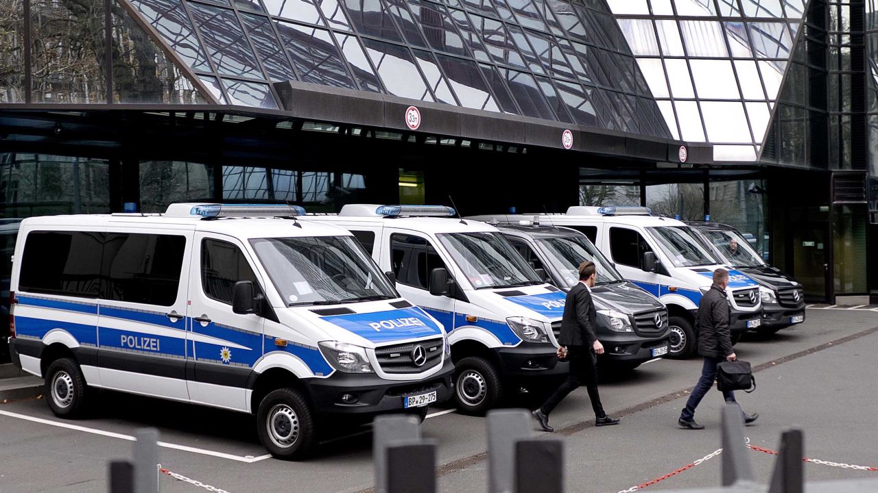 Police officers walk in the backyard of Deutsche Bank headquarters during a raid in Frankfurt, Germany, Thursday, Nov. 29, 2018. (AP Photo/Michael Probst)