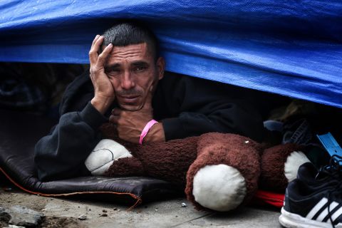 A migrant rests in his tent at the Benito Juarez Sports Complex, which is now a makeshift shelter in Tijuana, Mexico.