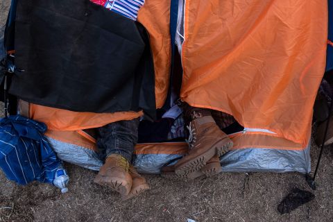 Many staying in the shelter are sleeping outdoors -- some in tents, some lying on the dirt in sleeping bags or blankets.