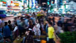 This picture taken on September 22, 2018 shows people walking in the streets of Shinjuku district of Tokyo. (Photo by Martin BUREAU / AFP)        (Photo credit should read MARTIN BUREAU/AFP/Getty Images)