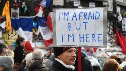A man holding a placard reading "I am afraid but I am here" during a gathering on Place de la Republique (Republic square) on January 10, 2016 in Paris, as the city marks a year since 1.6 million people thronged the French capital in a show of unity after attacks on the Charlie Hebdo newspaper and a Jewish supermarket. Just as it was last year, the vast Place de la Republique is the focus of gatherings as people reiterate their support for freedom of expression and remember the other victims of what would become a year of jihadist outrages in France, culminating in the November 13 coordinated shootings and suicide bombings that killed 130 people and were claimed by the Islamic State (IS) group. DOMINIQUE FAGET/AFP/Getty Images