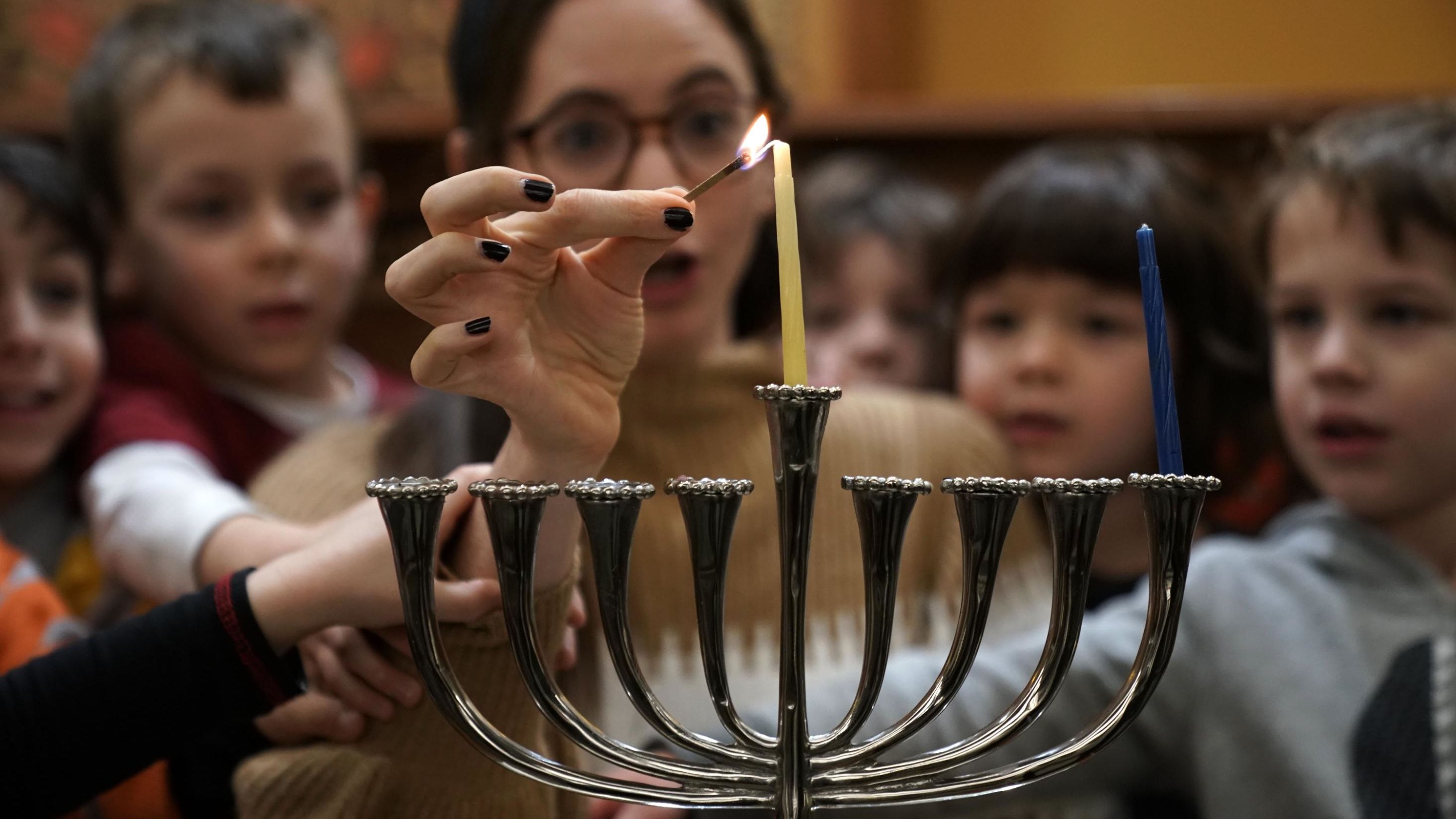 A small group of pre-schoolers from Gan HaYeled learn how to light a Hanukkah menorah from Rabbi Sarah Krinsky at Adas Israel Congregation November 30, 2018 in Washington, DC. This year, Hanukkah will begin at sundown on December 22 and last until sundown on December 30.