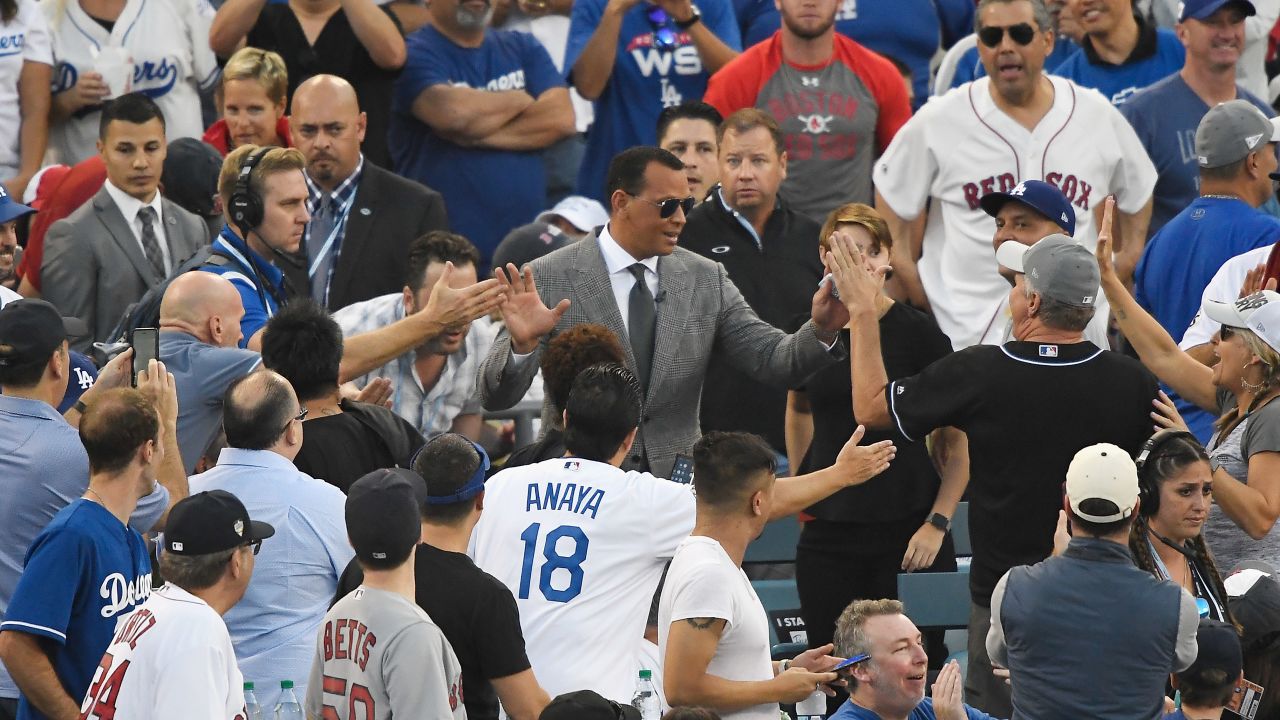 Alex Rodriguez (center, glasses) interacts with fans during the World Series at Dodger Stadium on October 27, 2018. The former MLB slugger has changed his public perception since retiring in 2016. 