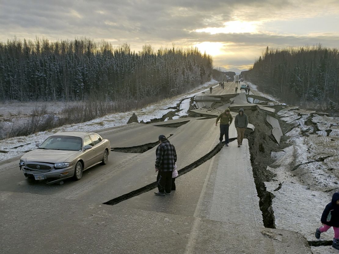 People walk along a road in Wasilla after Friday's earthquake. 