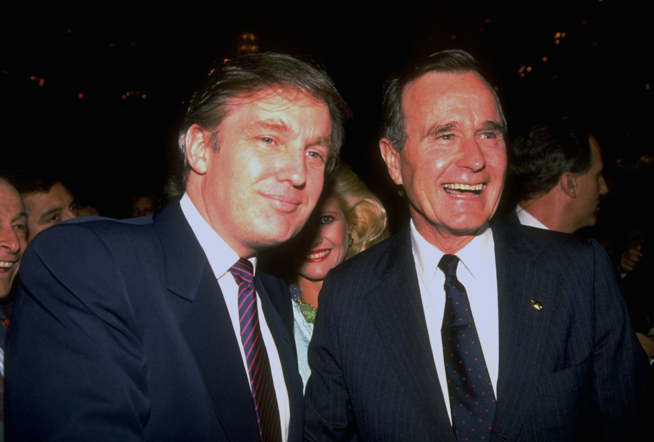 Bush poses for a photo with real estate mogul and future President Donald Trump during a campaign event in 1988.