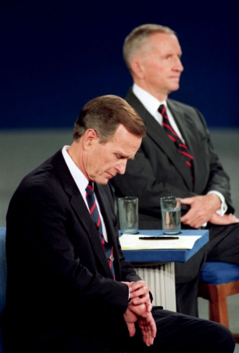 Bush checks his watch during a 1992 presidential debate with Ross Perot, right, and Bill Clinton. The memorable moment was interpreted as the President being out of touch.