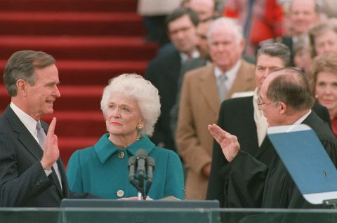 Bush was sworn into office as the 41st president of the United States on January 20, 1989. First lady Barbara Bush holds the Bible for her husband while Chief Justice William Rehnquist administers the oath of office.
