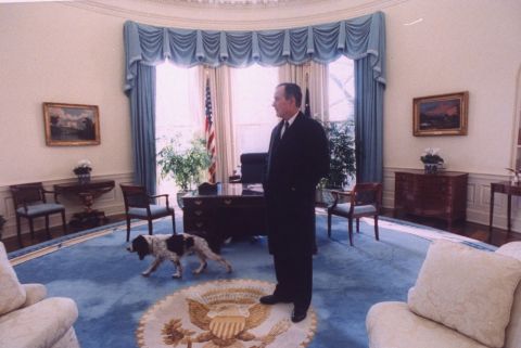 Bush takes a last look around the Oval Office with his dog, Ranger, before vacating the White House for Bill Clinton.