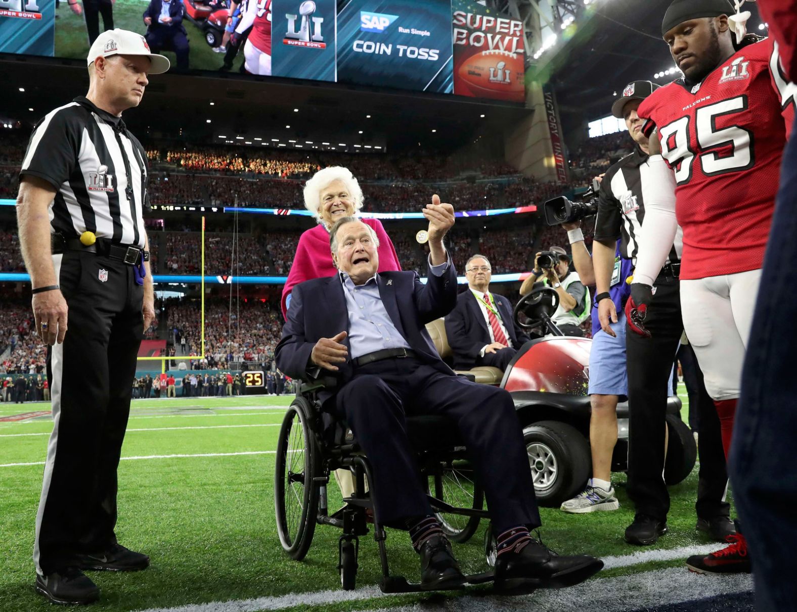 The Bushes participate in the ceremonial coin toss before the Super Bowl in 2017.
