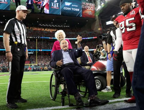 The Bushes participate in the ceremonial coin toss before the Super Bowl in 2017. 