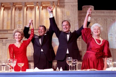 The Reagans and the Bushes join hands after President Reagan endorsed Bush's presidential run at a dinner in 1988.